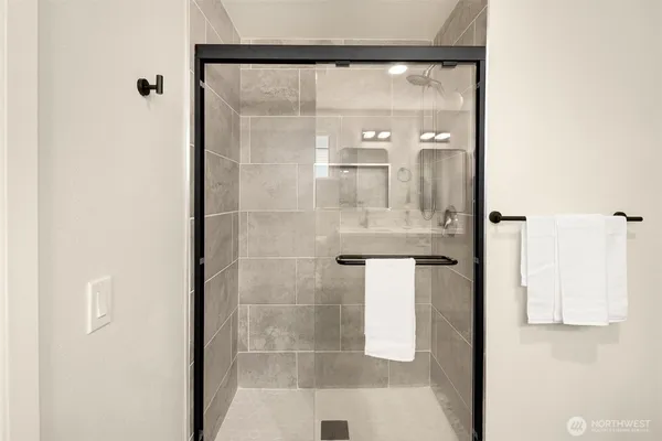 a bathroom with a glass shower door