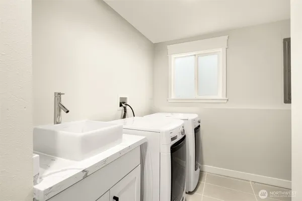a utility room with a sink dryer and washer