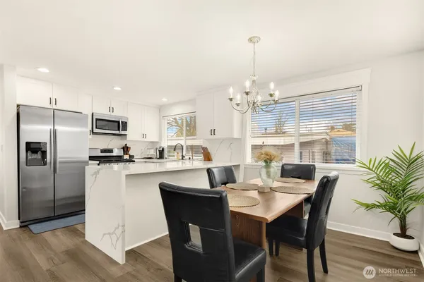a large kitchen with a table and chairs