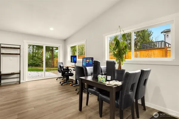 a dining room with furniture window and wooden floor