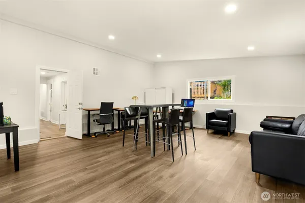 a living room with furniture a dining table and a flat screen tv