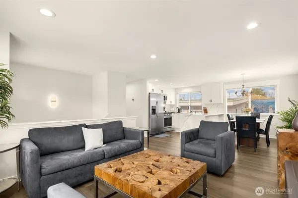 a living room with furniture and view of kitchen