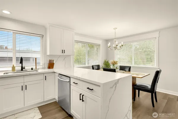 a kitchen with a sink and white cabinets