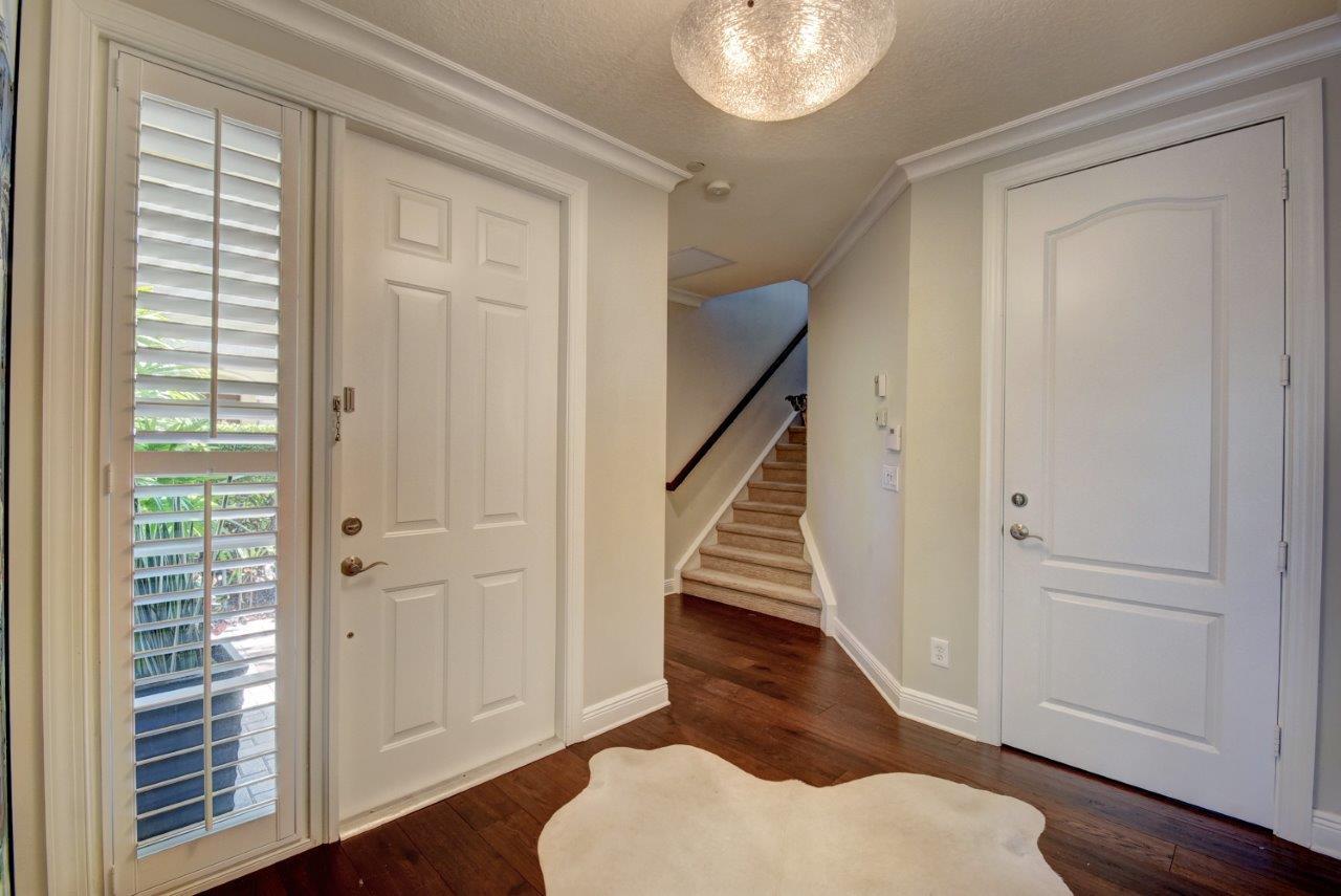 5610 Northeast Trieste Terrace Boca Raton, FL 33487 - Photo 5 of 44 a view of entryway with wooden floor and staircase