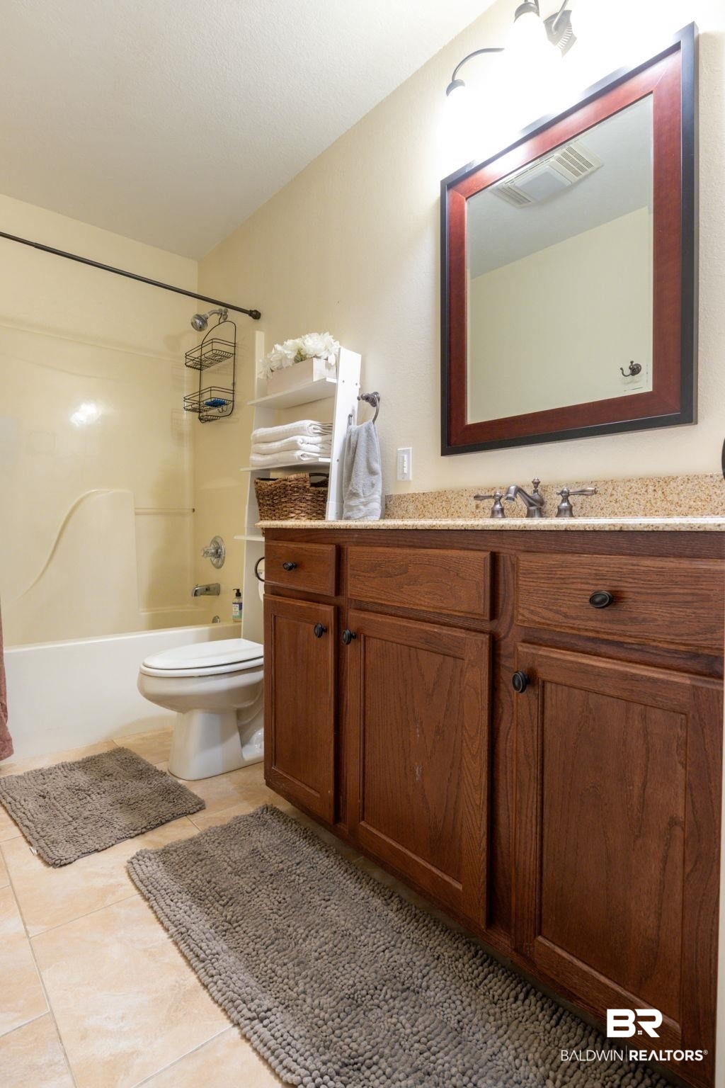 32345 River Lake Road Seminole, AL 36574 - Photo 36 of 56 Bathroom featuring shower / washtub combination, vanity, tile patterned flooring, visible vents, and toilet