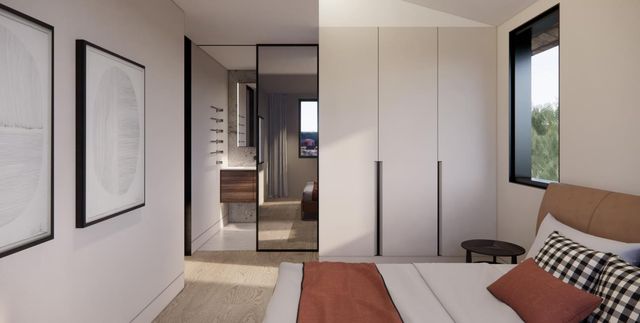 a bedroom with a bed lamp and a large window