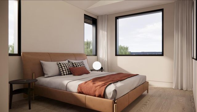 a bedroom with a bed and a night stand