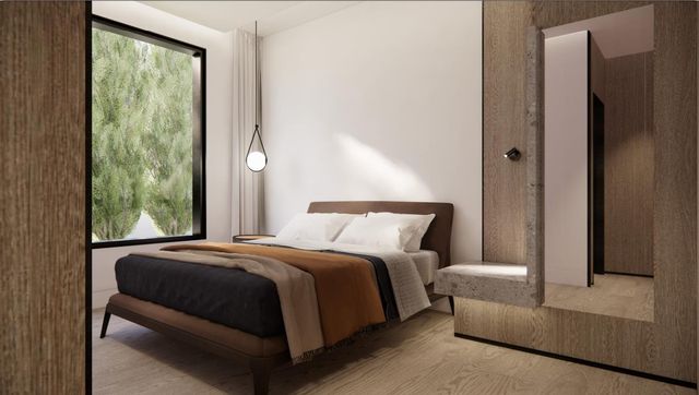 a bedroom with a bed and a painting on the wall