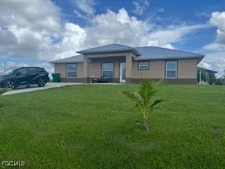 a front view of a house with a garden