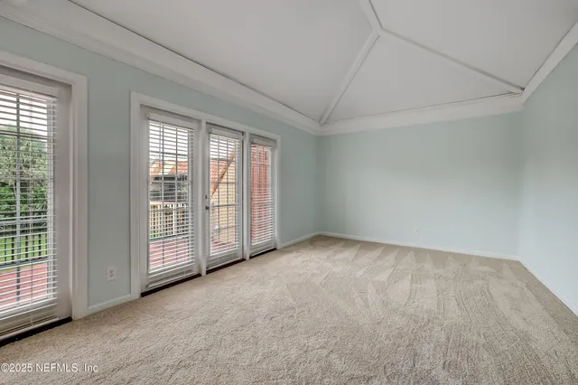 a view of an empty room with windows