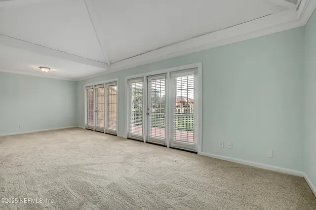 a view of an empty room with windows