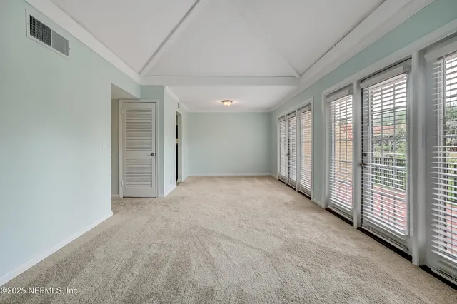a view of an empty room with a sliding door