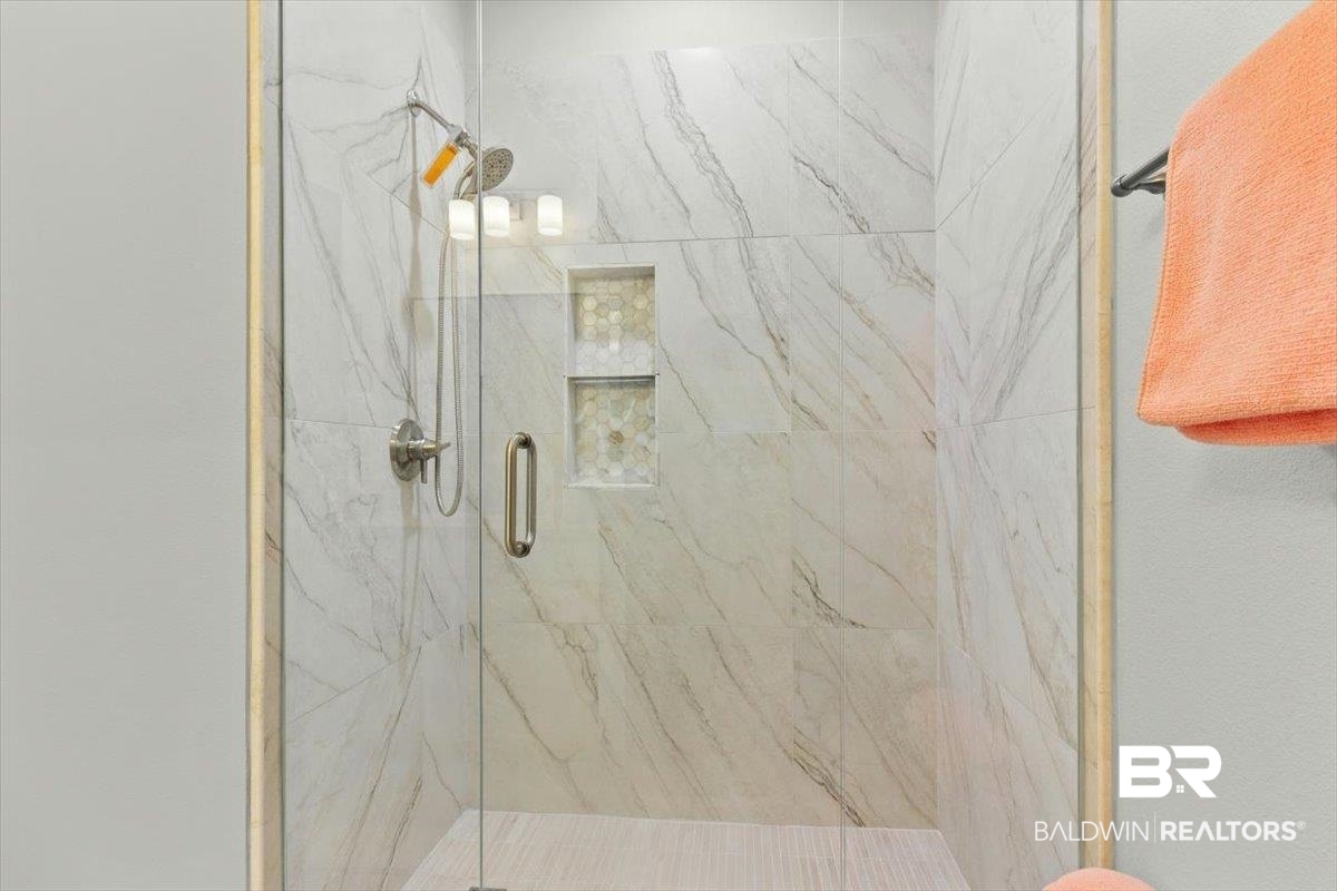 7056 Rocky Rd Loop Gulf Shores, AL 36542 - Photo 27 of 41 Full bathroom with a marble finish shower