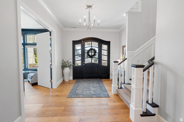 2917 Old Farm Road Washington, UT 84780 - Photo 14 of 105 Foyer entrance featuring hanging lights, light wood-style floors, and ornamental molding