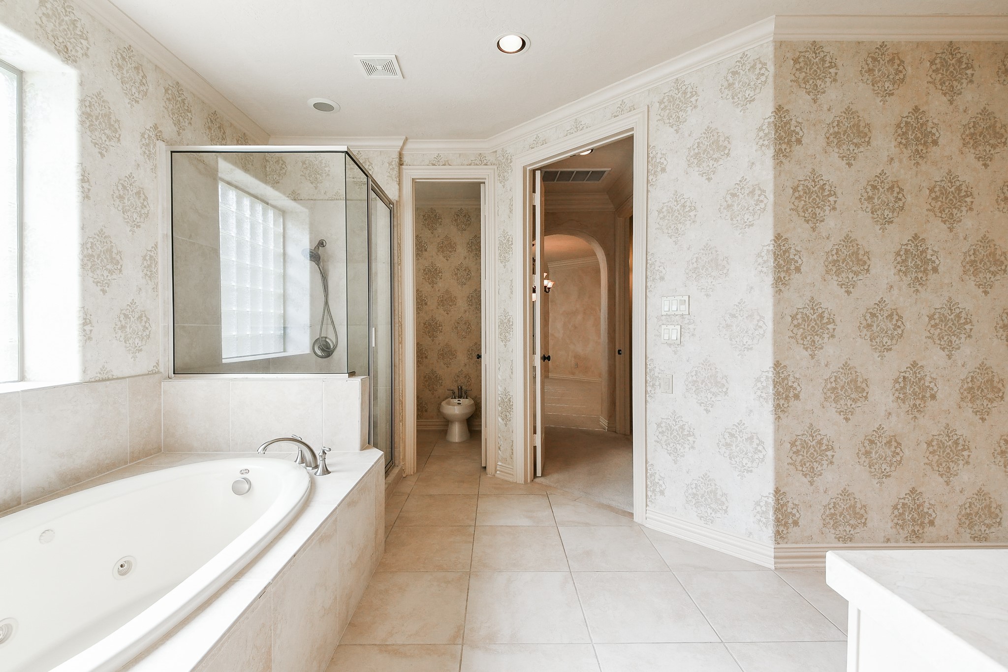 2014 Flower Garden Lane Houston, TX 77077 - Photo 18 of 32 a bathroom with a bathtub and a shower