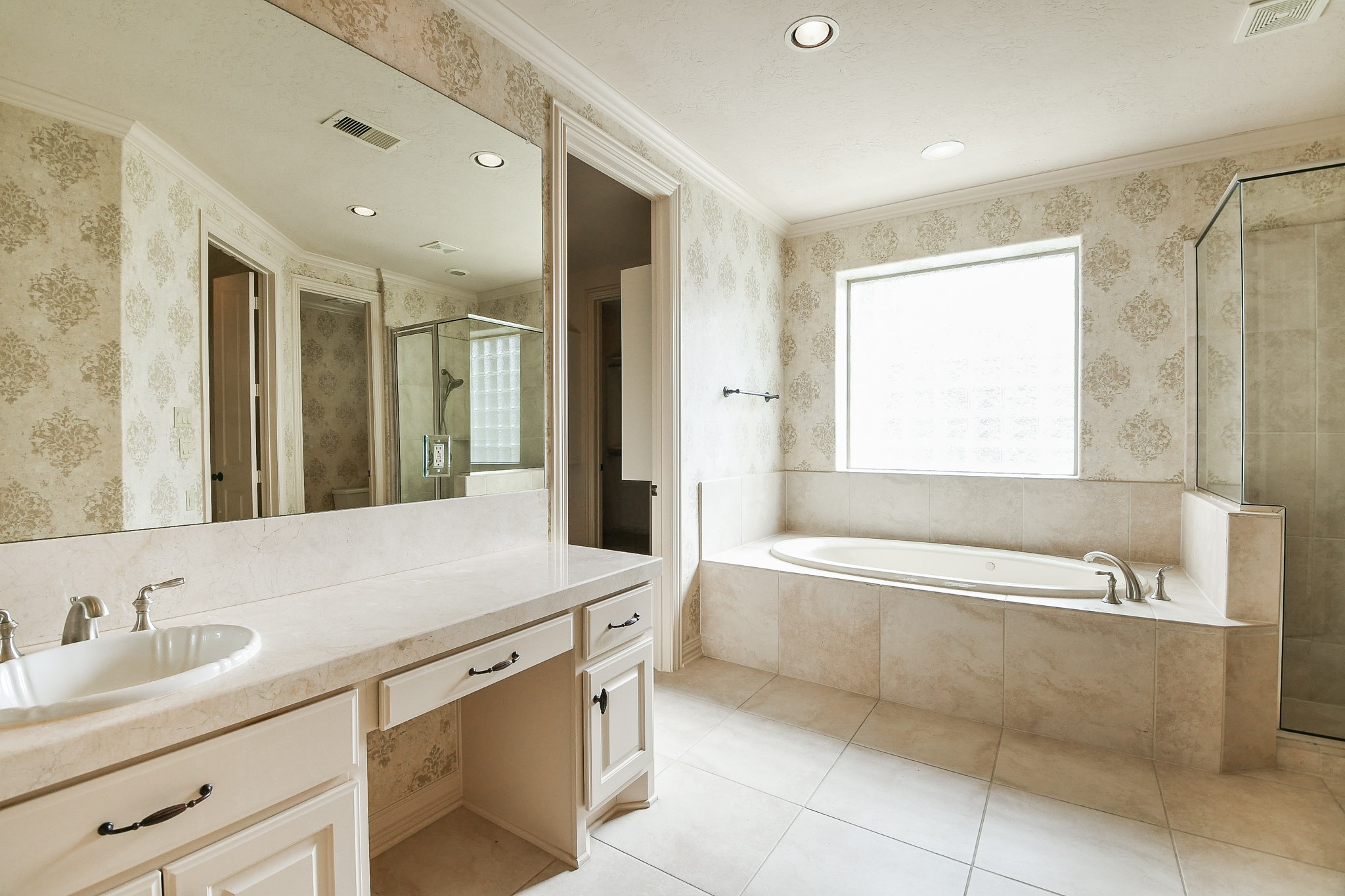 2014 Flower Garden Lane Houston, TX 77077 - Photo 19 of 32 a bathroom with a granite countertop sink mirror and a bathtub