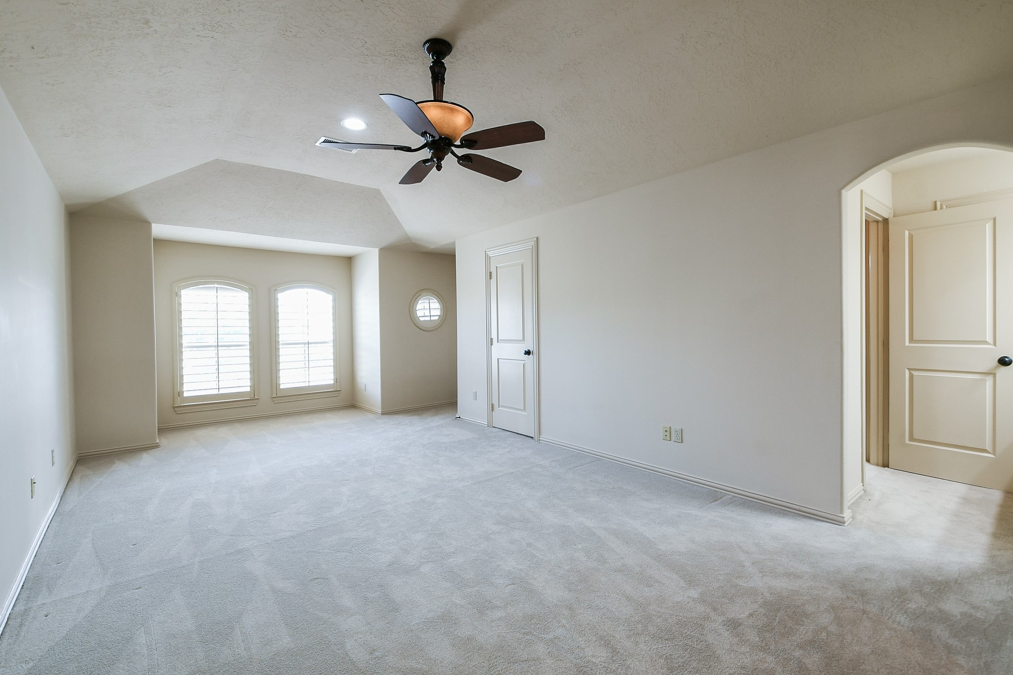 2014 Flower Garden Lane Houston, TX 77077 - Photo 24 of 32 an empty room with chandelier fan and windows