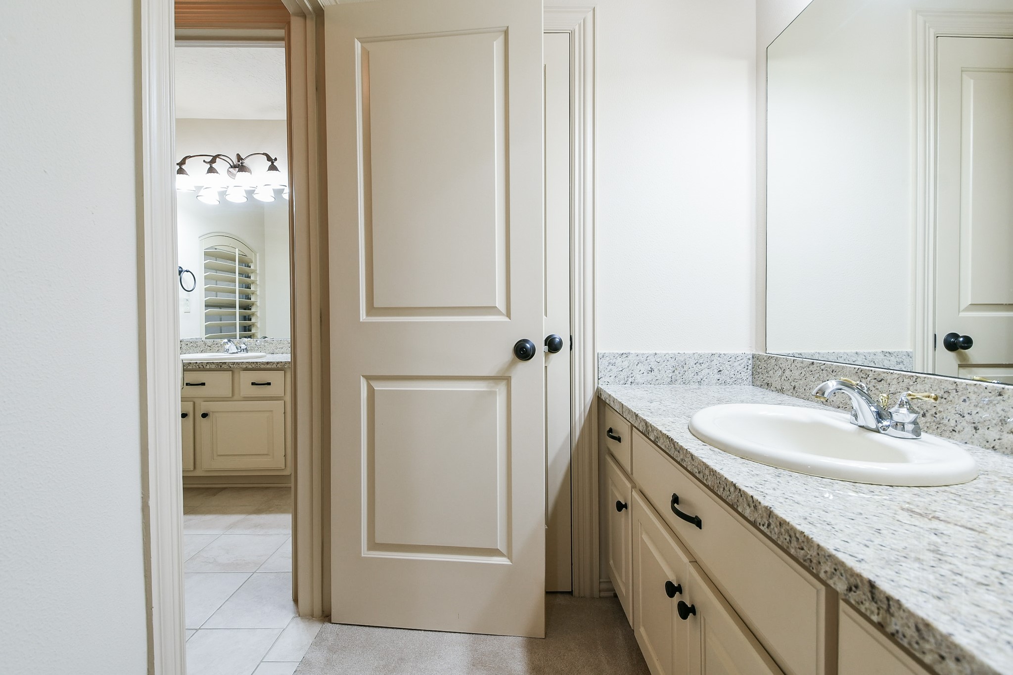 2014 Flower Garden Lane Houston, TX 77077 - Photo 26 of 32 a bathroom with a granite countertop sink and a mirror