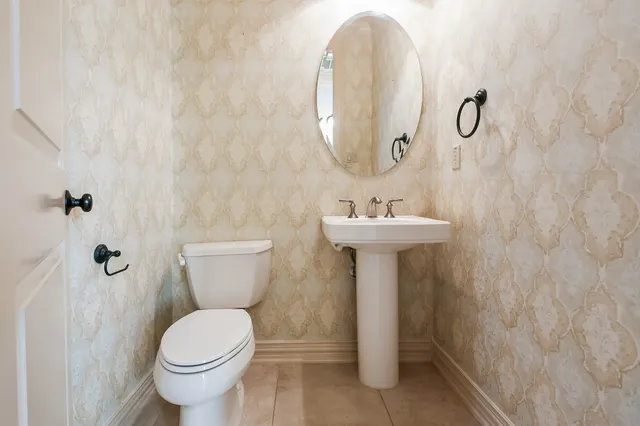 a view of a hallway with wooden floor and a kitchen