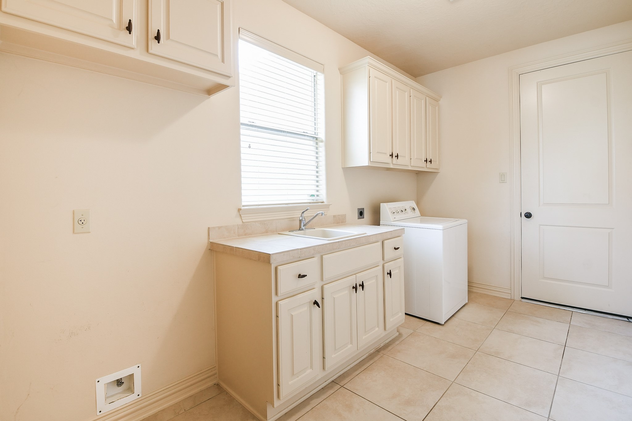 2014 Flower Garden Lane Houston, TX 77077 - Photo 29 of 32 a utility room with cabinets washer and dryer