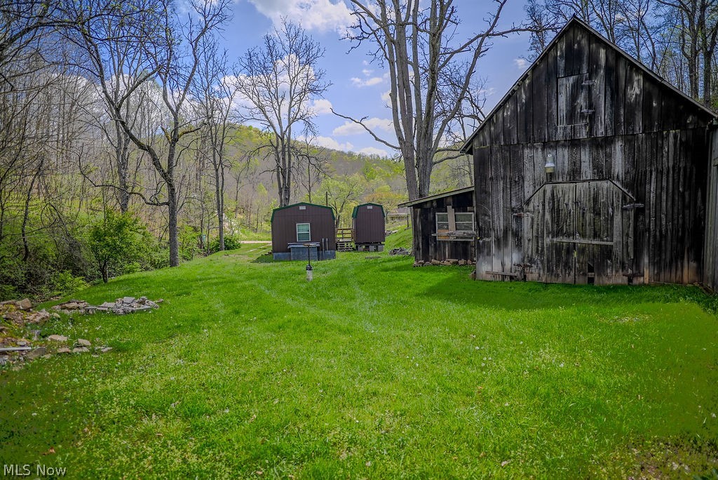 1547 Providence Road Elizabeth, WV 26143 - Photo 30 of 32 Expansive green lawn with a rustic wood-sided barn