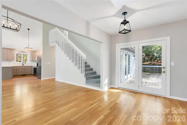 a view of empty room with fireplace and wooden floor