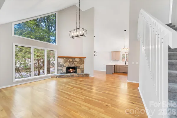 a view of an empty room with window and fire place