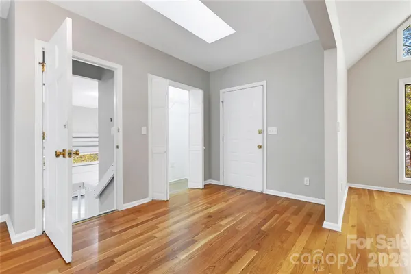a view of empty room with wooden floor