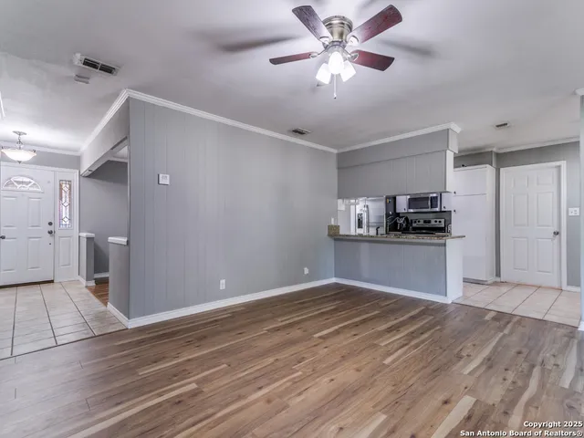 a view of a kitchen with a dishwasher and a stove top oven