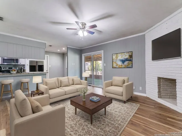 a living room with furniture a rug and a fireplace