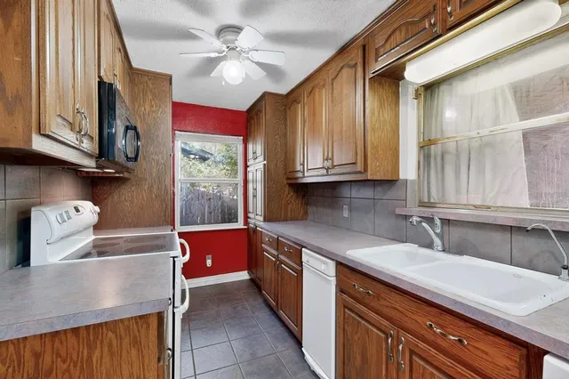 a kitchen with stainless steel appliances granite countertop a sink and cabinets