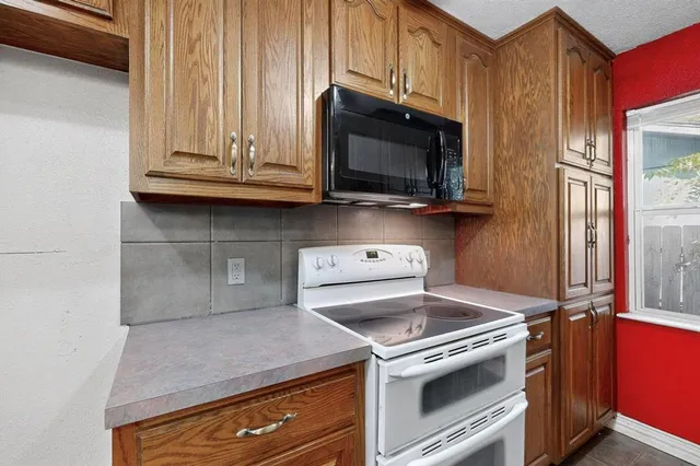 a kitchen with a stove and a microwave