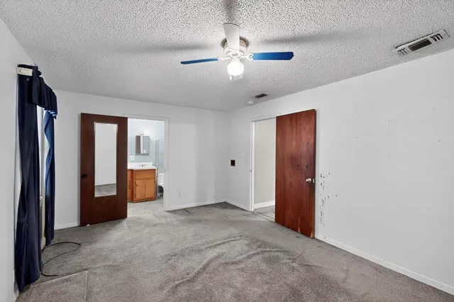 a view of an empty room with a bathroom