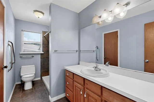 a bathroom with a sink a toilet and a mirror