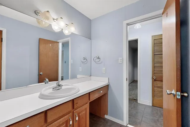 a bathroom with a sink double vanity granite and a mirror