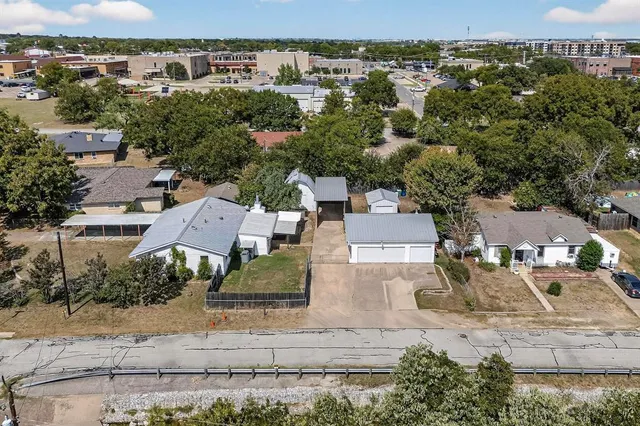 an aerial view of residential houses with outdoor space