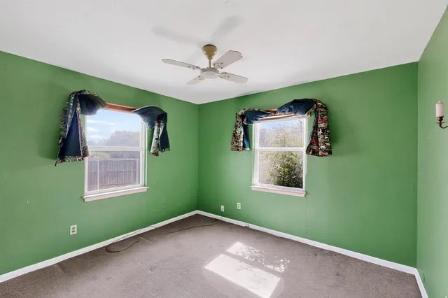 a view of a room with window ceiling fan and a window