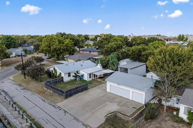 an aerial view of a house with garden space and street view