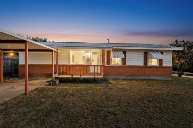 a view of a house with a backyard