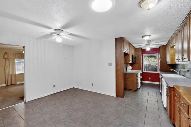 wooden floor in an empty room with a kitchen