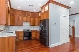 a kitchen with stainless steel appliances granite countertop a refrigerator and a sink