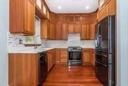 a kitchen with stainless steel appliances granite countertop a stove a sink and a refrigerator