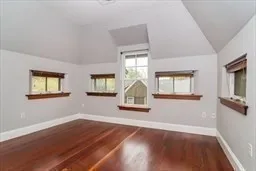 a view of a livingroom with wooden floor windows and a ceiling fan