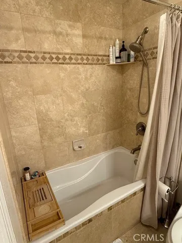 a bathroom with a shower and a tub