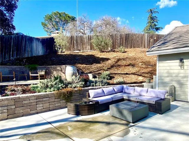a outdoor living space with furniture and a fireplace