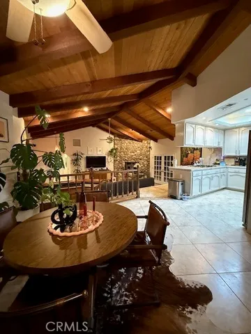 a view of a dining room with furniture and a chandelier