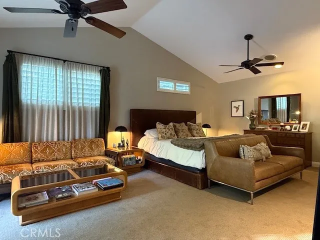 a living room with furniture ceiling fan and a window