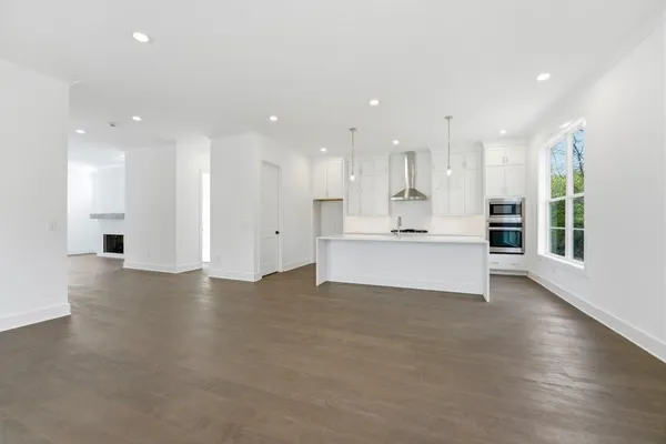 a view of kitchen with kitchen island and stainless steel appliances