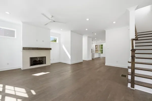 a view of a livingroom with fireplace and window