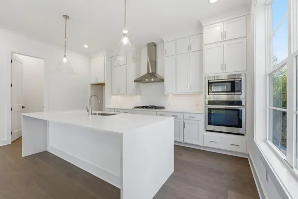 a kitchen with a sink stainless steel appliances and cabinets